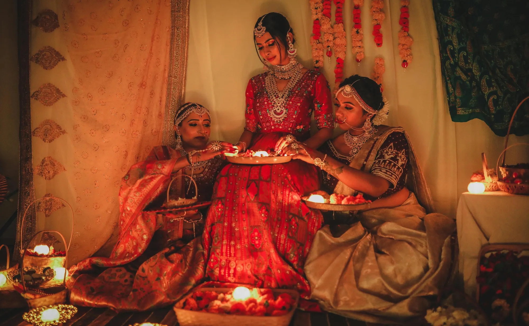 Bridal-wear campaign: three women lighting diyas